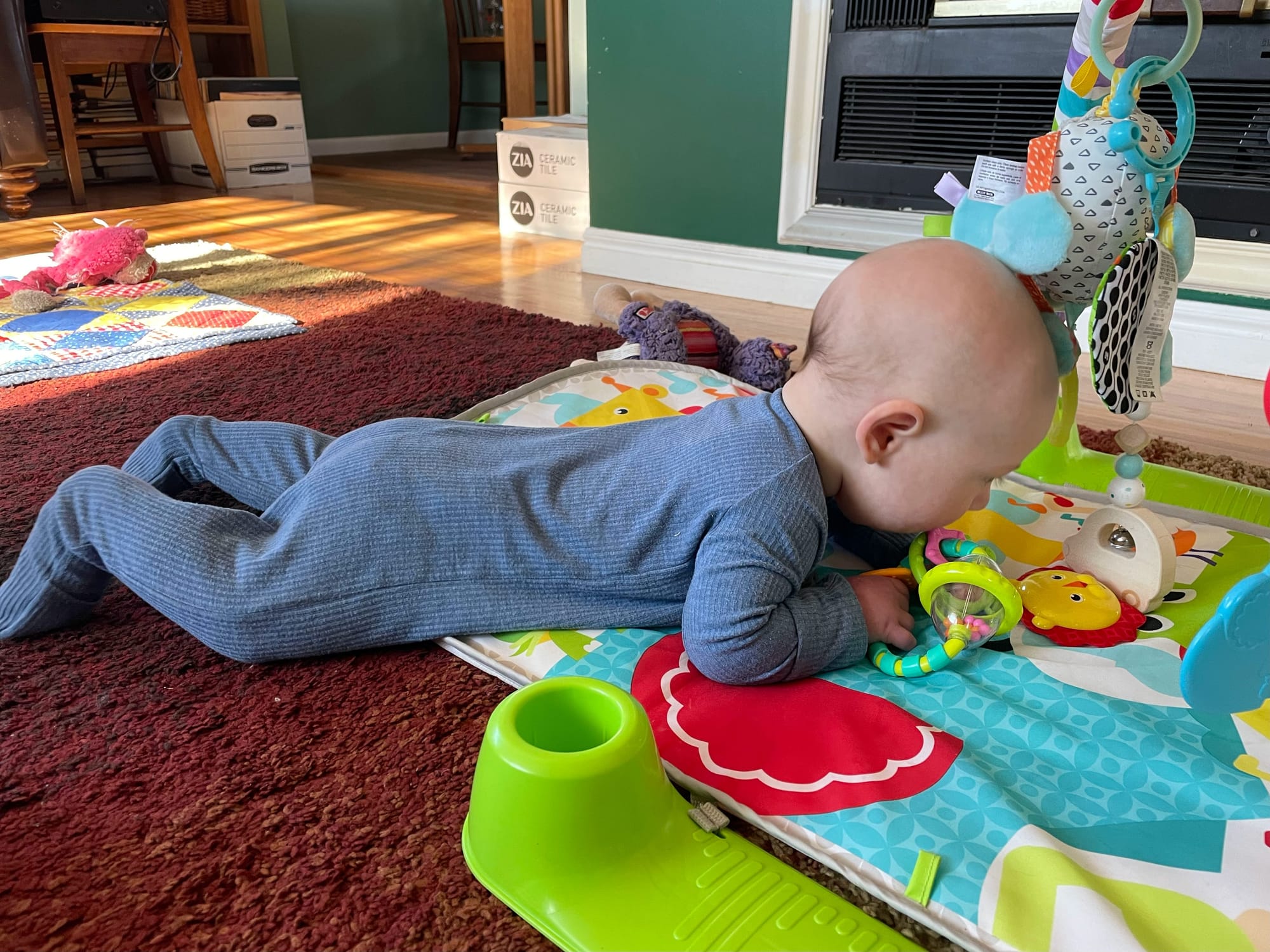 Four-month-old baby lifting chest off the floor during tummy time