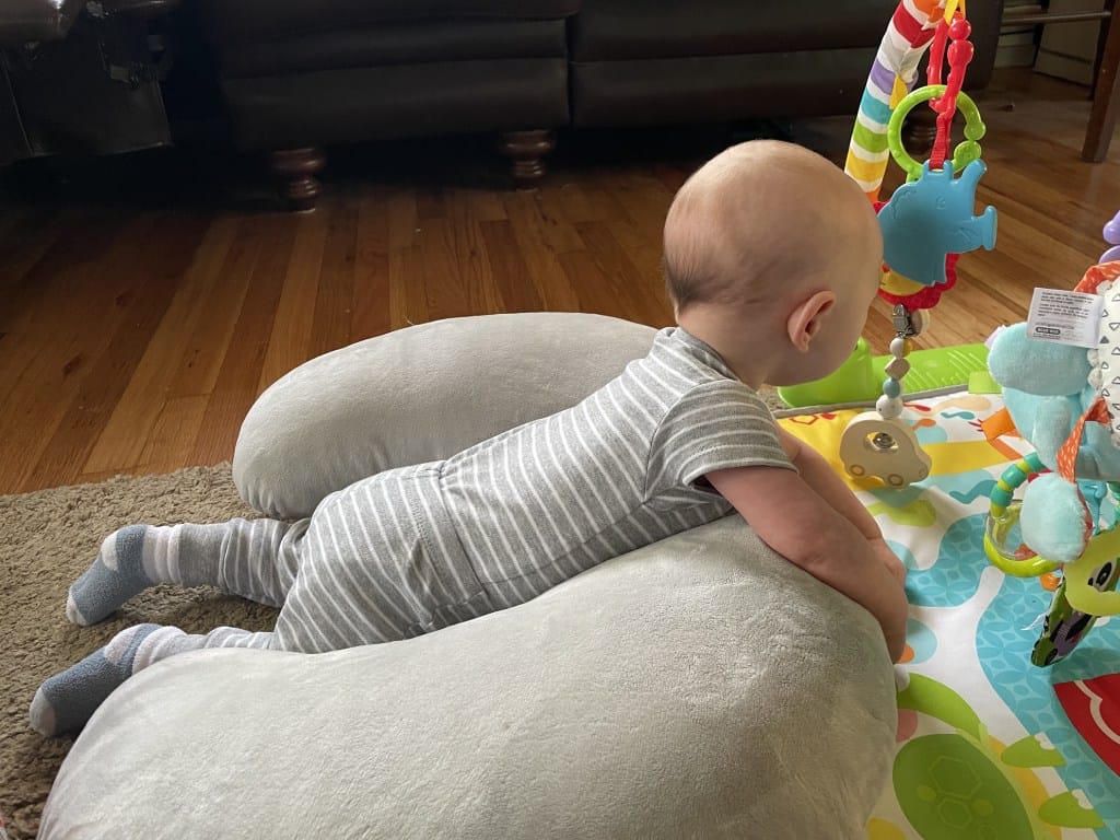 Three-month-old baby playing on their tummy during floor time