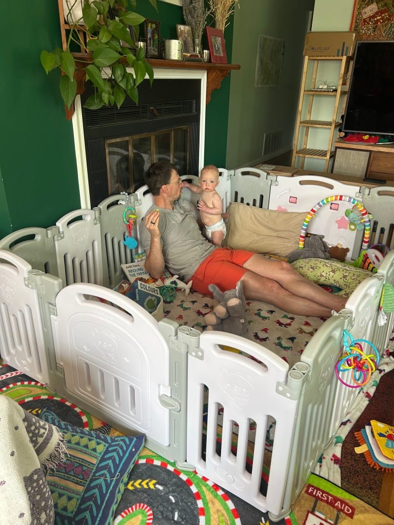 Baby playing safely inside a play pen
