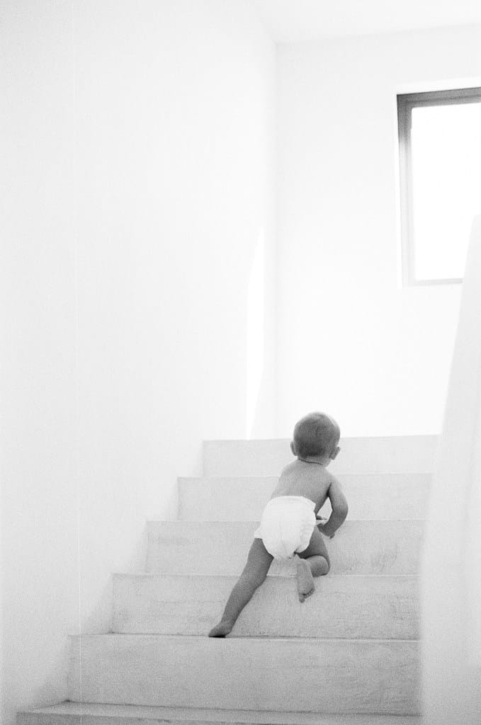 Baby crawling up carpeted stairs