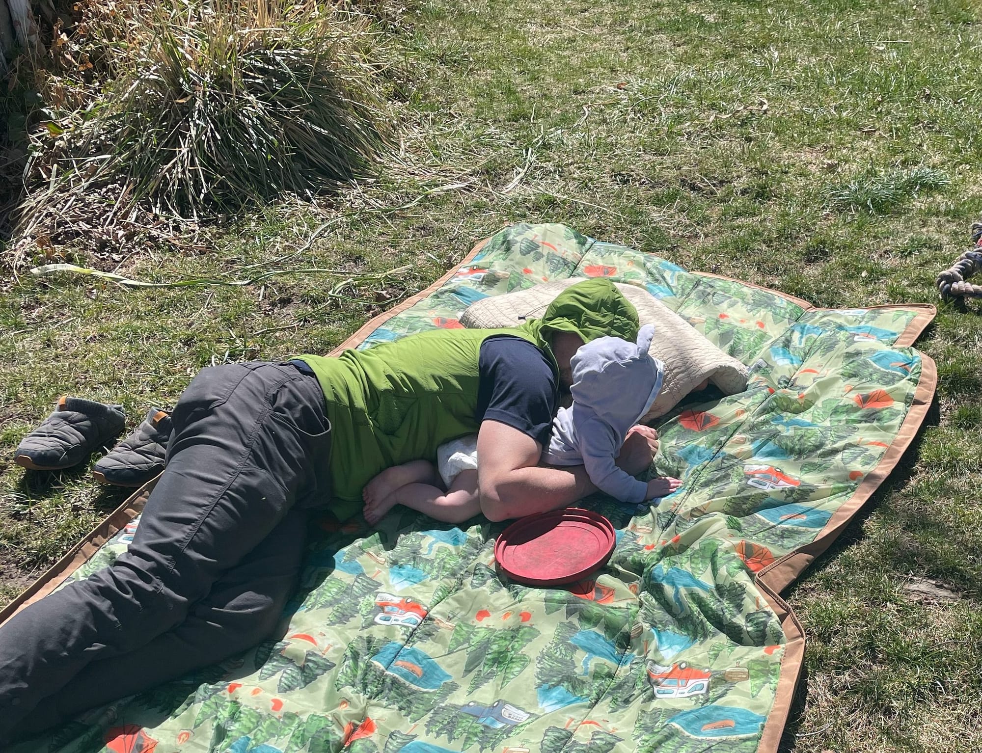 Baby doing tummy time outdoors on a blanket