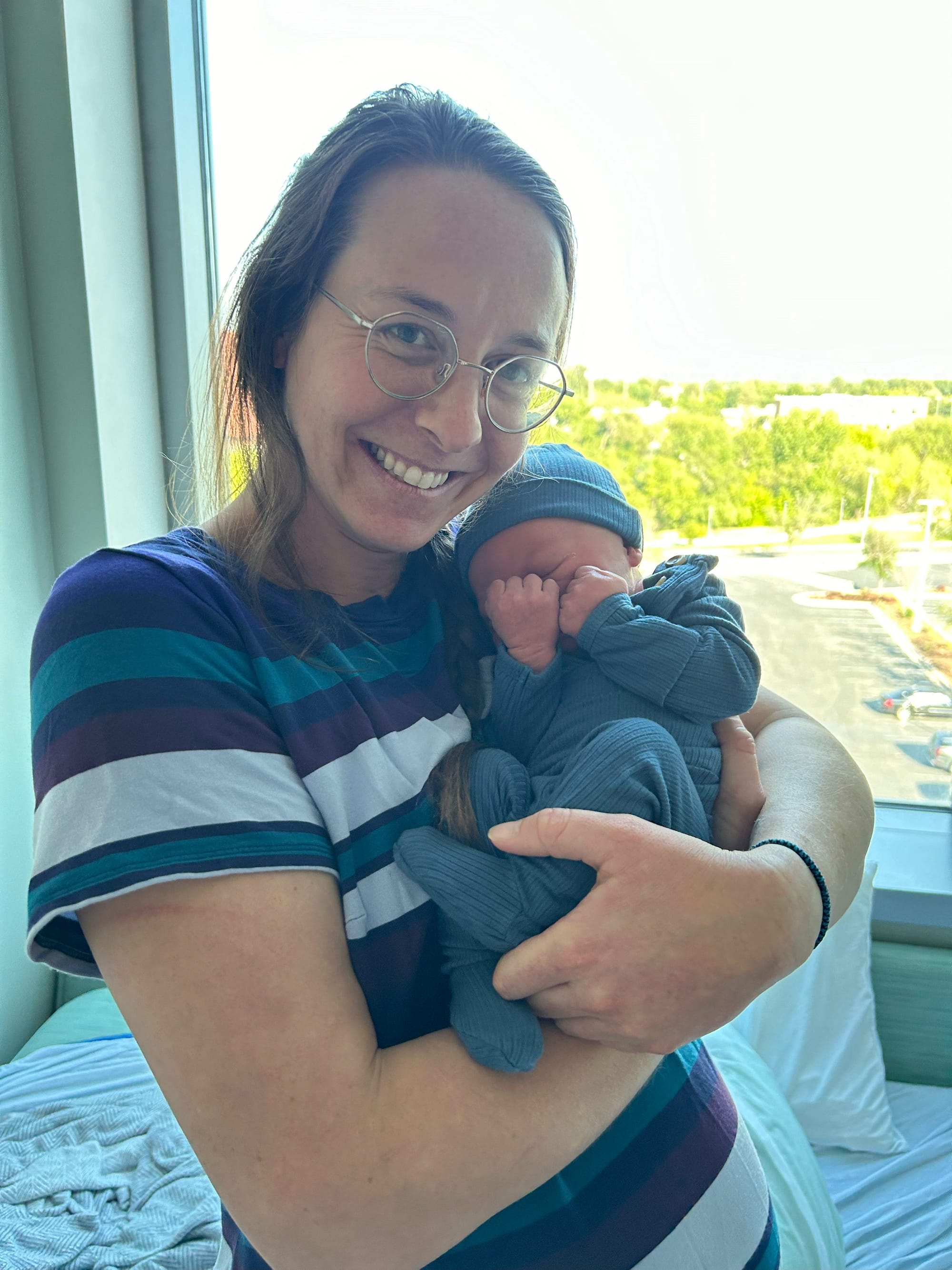 Newborn curled in a physiological flexion position with arms and legs tucked in